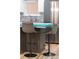 Island seating provides a cozy spot in this kitchen with stainless steel appliances and undermount lighting at 3295 Blake St # 102, Denver, CO 80205