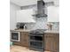 Modern kitchen with stainless steel appliances, custom cabinetry, and a decorative backsplash at 3295 Blake St # 102, Denver, CO 80205