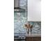 Stylish kitchen backsplash featuring decorative tile, a stainless steel range hood, and modern fixtures at 3295 Blake St # 102, Denver, CO 80205