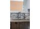 Modern kitchen sink with stylish faucet, decorative backsplash, and a bright window at 3295 Blake St # 102, Denver, CO 80205