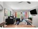 Bright living room featuring a comfortable sofa, modern lighting, and a sliding door to the balcony with a view at 3295 Blake St # 102, Denver, CO 80205