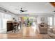 Open-concept living and bar area with hardwood floors and plenty of natural light at 3295 Blake St # 102, Denver, CO 80205
