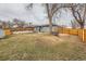 Large backyard with grass, mature trees, wooden fence, and plenty of space at 9295 E 12Th Ave, Aurora, CO 80010