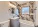 Updated bathroom featuring stylish tile, vanity, and a shower-tub combo at 9295 E 12Th Ave, Aurora, CO 80010