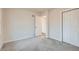 Bright bedroom featuring neutral walls, carpeting, and a closet at 9295 E 12Th Ave, Aurora, CO 80010