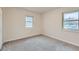 Comfortable bedroom with neutral paint, soft carpet, and natural light from two windows creating a relaxing space at 9295 E 12Th Ave, Aurora, CO 80010