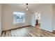 Inviting dining space with wood floors and a modern light fixture, adjacent to a bright, updated kitchen at 9295 E 12Th Ave, Aurora, CO 80010