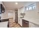 Modern kitchen with stainless steel appliances and bright white cabinets at 9295 E 12Th Ave, Aurora, CO 80010