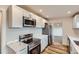 Beautifully updated kitchen featuring white cabinets, stainless steel appliances, and stylish countertops at 9295 E 12Th Ave, Aurora, CO 80010