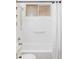 This bath features a white tiled shower/tub combination at 822 S Worchester St, Aurora, CO 80012