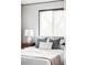 A peaceful bedroom features lots of light and neutral décor at 822 S Worchester St, Aurora, CO 80012