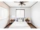 A bright bedroom showcasing a ceiling fan, hardwood floors and neutral tones at 822 S Worchester St, Aurora, CO 80012