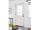 Close up of the front door featuring glass design elements, adjacent to window at 822 S Worchester St, Aurora, CO 80012