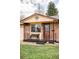 Close-up of the home's front porch featuring a cozy bench and decorative door at 822 S Worchester St, Aurora, CO 80012
