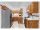 The kitchen features stainless steel appliances and wooden cabinets at 822 S Worchester St, Aurora, CO 80012