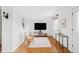 An airy living room features stylish furnishings and a large screen television at 822 S Worchester St, Aurora, CO 80012