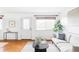 Open living room with a bright white door and window and plenty of natural light at 822 S Worchester St, Aurora, CO 80012