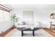 Bright living room with hardwood floors, stylish furniture, and natural light at 822 S Worchester St, Aurora, CO 80012