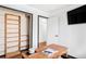 Office area featuring a custom wall unit, modern decor, and ample natural light at 822 S Worchester St, Aurora, CO 80012