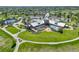 Aerial view of a clubhouse with a pool, outdoor seating, and lush green lawns and landscaping at 14879 Xenia St, Thornton, CO 80602