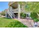 Well-maintained backyard featuring a patio with outdoor seating and a staircase to the upper level at 14879 Xenia St, Thornton, CO 80602