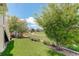 Serene backyard featuring lush green lawn, mature trees, and a view of the surrounding neighborhood at 14879 Xenia St, Thornton, CO 80602