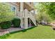 Lush backyard with a covered patio, surrounded by green grass and mature landscaping at 14879 Xenia St, Thornton, CO 80602