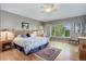 Serene bedroom with hardwood floors, large window, and comfortable furniture at 14879 Xenia St, Thornton, CO 80602