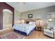 This bright bedroom features light-colored hardwood floors and ensuite bathroom access at 14879 Xenia St, Thornton, CO 80602