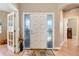 Inviting foyer with a decorative glass door, hardwood floors, and elegant interior design at 14879 Xenia St, Thornton, CO 80602
