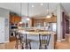 Bright kitchen features a large island, pendant lighting, and stainless-steel appliances at 14879 Xenia St, Thornton, CO 80602