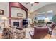 Open-concept living room featuring vaulted ceilings, large windows, fireplace, and comfortable seating at 14879 Xenia St, Thornton, CO 80602