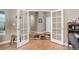 Open office area with natural light streaming in through the french doors at 14879 Xenia St, Thornton, CO 80602
