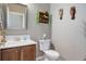 Cozy powder room featuring stylish vanity, decorative mirror, and unique wall accents at 14879 Xenia St, Thornton, CO 80602