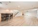 Spacious basement featuring a stone-accented bar, modern flooring, and staircase at 1260 S Duquesne Cir, Aurora, CO 80018