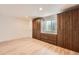 Spacious basement showcasing built-in cabinets and a window, ideal for storage and natural light at 1260 S Duquesne Cir, Aurora, CO 80018