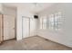 Bedroom with neutral carpet, white walls, built-in TV, and double windows with shutters at 1260 S Duquesne Cir, Aurora, CO 80018
