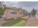 Home's exterior with a putting green, a small deck, and rock landscaping at 1260 S Duquesne Cir, Aurora, CO 80018