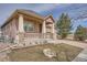 Inviting home with a covered front porch and well-maintained landscaping at 1260 S Duquesne Cir, Aurora, CO 80018