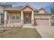 Charming single-Gathering home featuring a covered porch and stone accents at 1260 S Duquesne Cir, Aurora, CO 80018