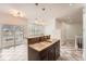 Open kitchen concept with a center island, stainless steel faucet, and pendant lighting at 1260 S Duquesne Cir, Aurora, CO 80018