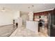 Open kitchen layout with stainless steel appliances and a center island with bar seating at 1260 S Duquesne Cir, Aurora, CO 80018