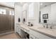 Bright bathroom with dual sinks, light countertops, and a tiled walk-in shower at 17121 Desert Wine Ln, Parker, CO 80134