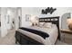 Tastefully decorated bedroom with a dark wood bed frame and a modern art piece on the wall at 17121 Desert Wine Ln, Parker, CO 80134