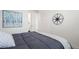 Bright bedroom with a comfortable bed, stylish artwork, and a decorative compass on the wall at 17121 Desert Wine Ln, Parker, CO 80134
