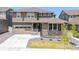 Charming two-story home showcasing stone accents, manicured lawn, and welcoming entrance at 17121 Desert Wine Ln, Parker, CO 80134
