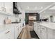 Bright, open kitchen with quartz countertops, white cabinetry, stainless steel appliances, and modern fixtures at 17121 Desert Wine Ln, Parker, CO 80134