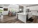 Open concept kitchen featuring quartz countertops, stainless steel appliances, and seamless flow to the living area at 17121 Desert Wine Ln, Parker, CO 80134