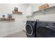 Well-organized laundry room featuring modern appliances and charming decor at 17121 Desert Wine Ln, Parker, CO 80134