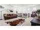 Bright living room with leather sofa, statement cowhide rug, and natural light from multiple windows at 17121 Desert Wine Ln, Parker, CO 80134